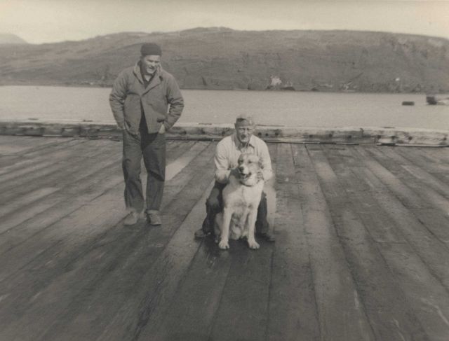 Boatswain Petersen with dog and Woodrow Gholston on pier at Kiska Picture