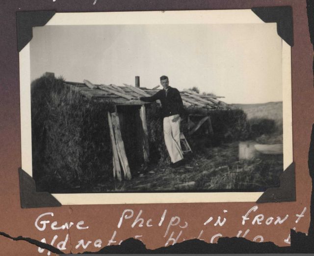 Gene Phelps in front of an old native Aleut hut. Picture