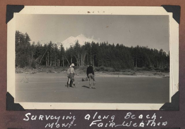Surveying along the beach with Mount Fairweather in the background. Picture
