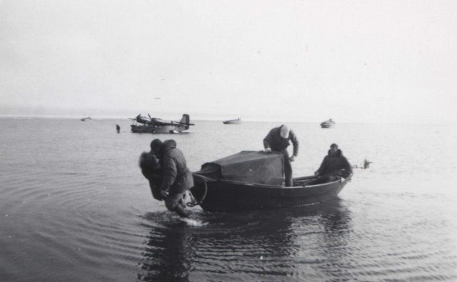 Walking a skiff into shore from the seaplane Picture