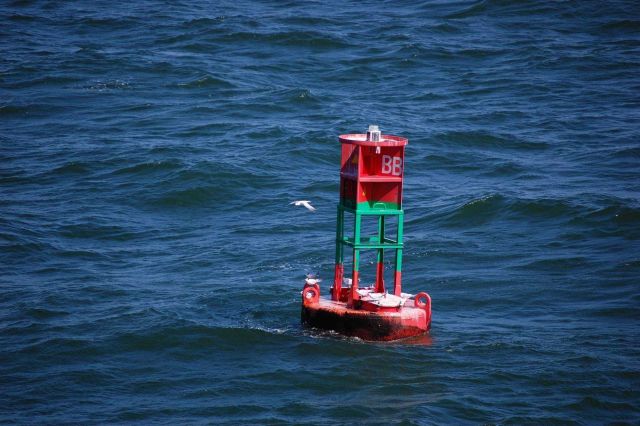 Preferred channel buoy with red top meaning pass buoy to starboard side when returning from sea. Picture