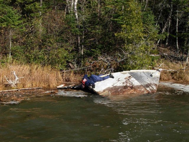 Coast Guardsman checking sunken vessel prior to recovering as marine debris. Picture