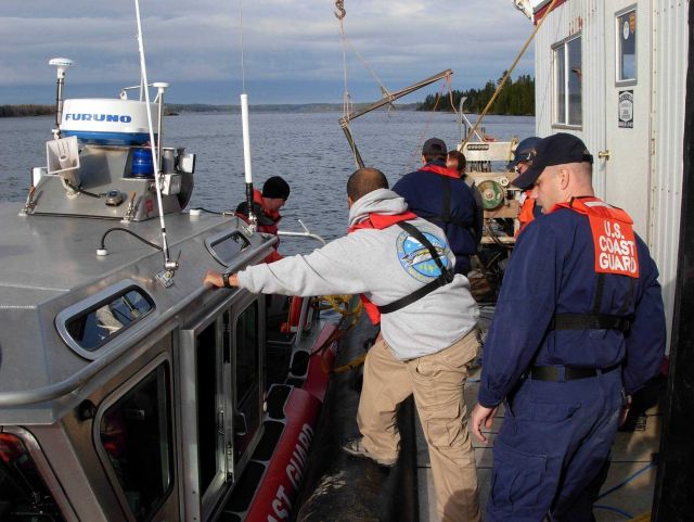 NOAA Navigation Response Team member and Coast Guard personnel preparing for cooperative work outside of Eastport, Maine. Picture