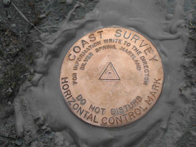 Freshly set Coast Survey horizontal control mark used in hydrographic survey operations. Picture