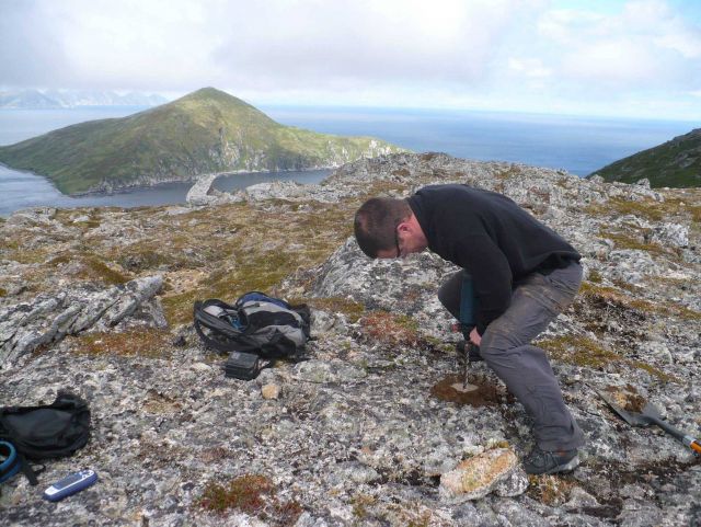 Using a power drill to drill a hole for placing a survey mark. Picture