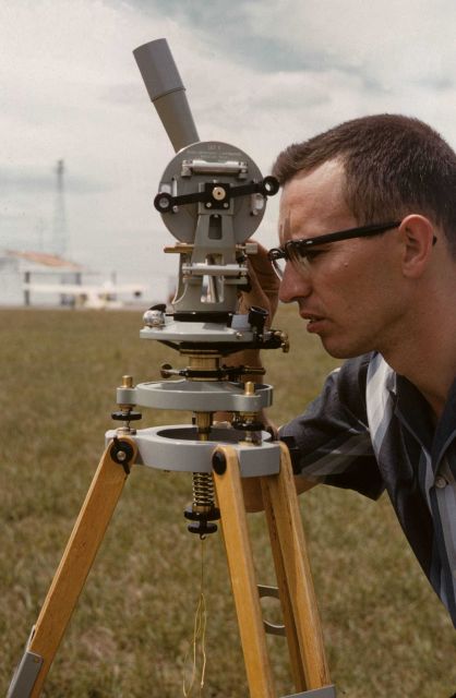 Surveyor taking sun azimuth for true direction to determine magnetic declination from magnetic observations. Picture