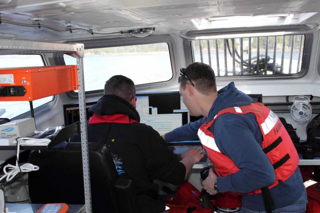 Survey techs in survey launch during hydrographic operations. Picture