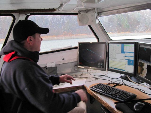 Hydrographic survey technician monitoring sonar. Picture