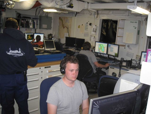 Processing survey data in the plot room of the NOAA Ship FAIRWEATHER. Picture