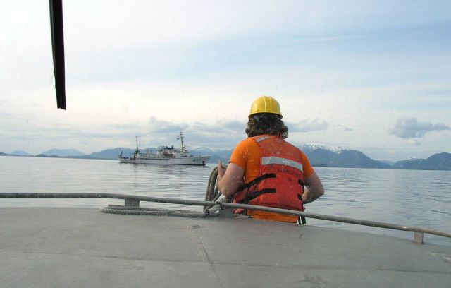 Bow hook preparing to cast line aboard ship prior to securing hook. Picture