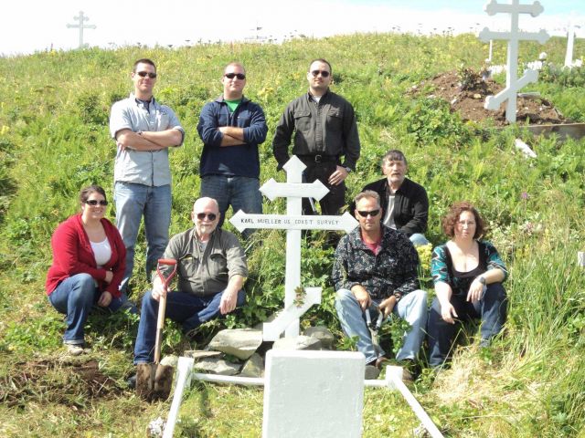 Officers and crew of NOAA Ship FAIRWEATHER tending to grave of Karl Mueller, who died in the line of duty surveying the shores of Alaska. Picture