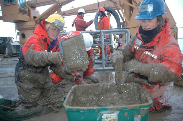 Katrin Iken (left) and Bodil Bluhm move deep-sea mud from the trawl net to a bucket Picture