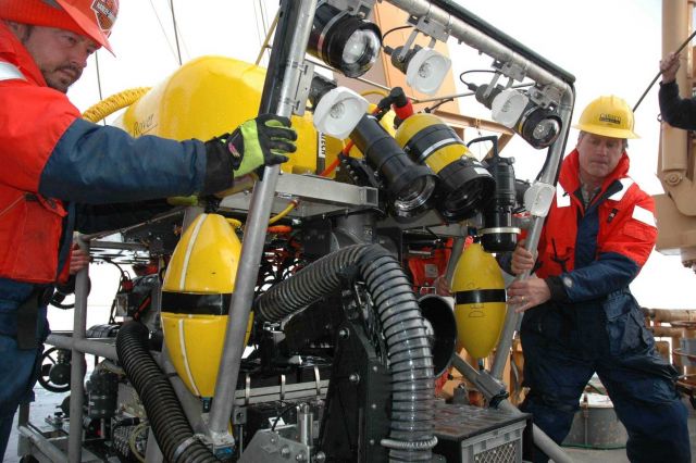 Mike Nicholson (left) and Joe Caba (right) move the ROV into position for deployment. Picture