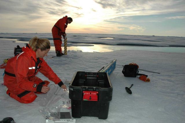 Rolf Gradinger works on an ice core while Mette Nielson takes measurements on a core already brought to the surface. Picture