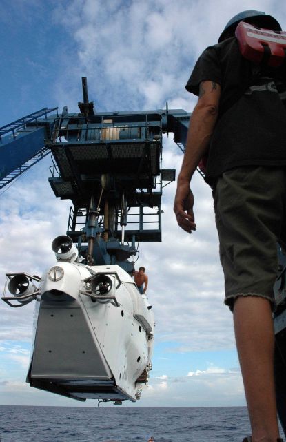 As ALVIN Launch Coordinator for the dive, pilot Gavin Eppard pays close attention as the sub is gently lowered into the Gulf of Mexico. Picture