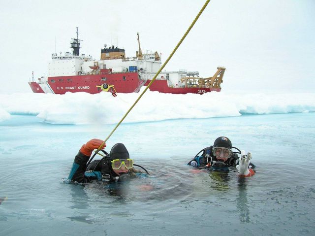 Ice Divers Katrin Iken (left) and Elizabeth Calvert (right) are about to descend through a small hole in the ice and into the frigid world below. Picture