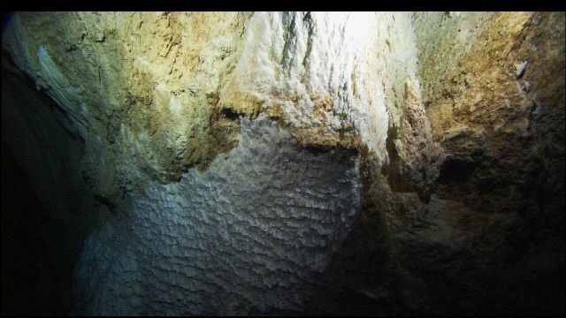 A honeycomb-like structure on the side of a Lost City spire. Picture