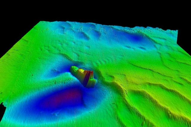 Tug with current scour marks around wreck Picture