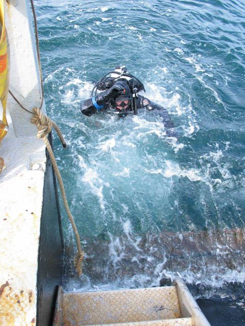 Tane Casserley entering water from the expedition vessel Big Valley. Picture