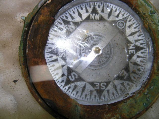The card of the compass is still intact revealing the manufacturer and date of the compass patent. Picture