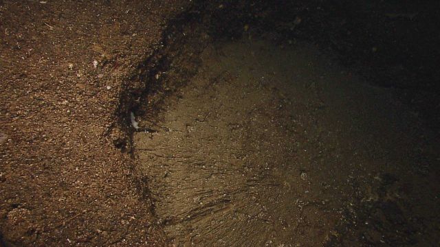 A circular geologic feature with seeming radial fractures. Picture