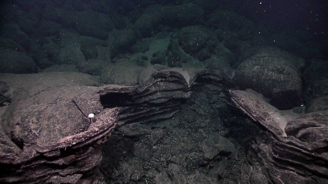 An archway formed by lava pillars supporting a remnant of intact lobate lava flow crust within a large collapsed lava lake Picture