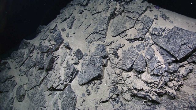 Broken flat slabs of rock (sheet lava?) on side of ridge Picture