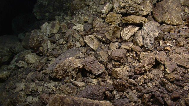 Broken jumbled mass of hydrothermally altered rocks indicating possible proximity to hydrothermal venting. Picture