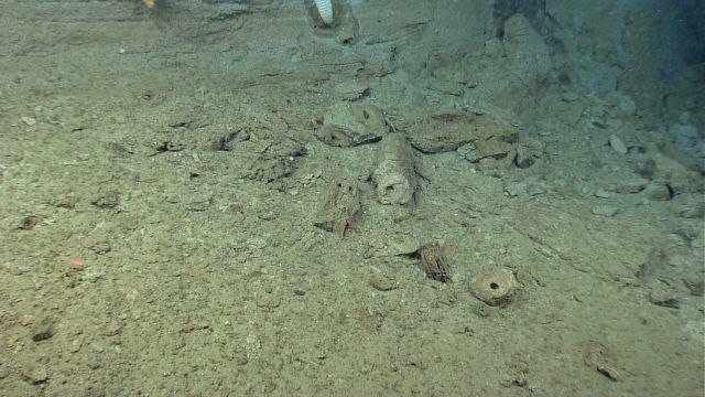 Broken fossil burrow material on the seafloor at the base of an escarpment. Picture