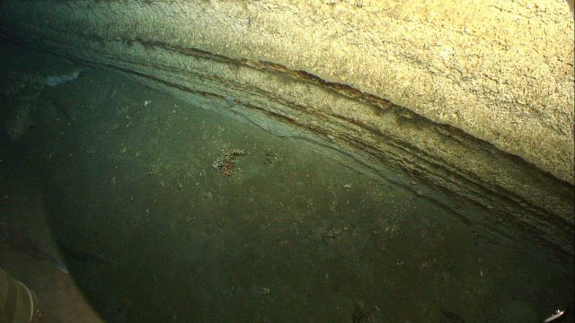 Horizontal sedimentary rock layers showing effects of differential erosion. Picture