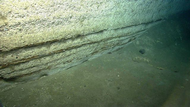 Horizontal sedimentary rock layers showing effects of differential erosion. Picture
