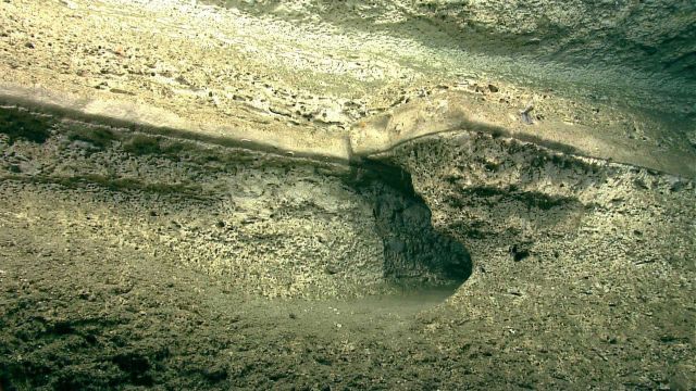 Horizontal sedimentary rock layers showing effects of differential erosion. Picture