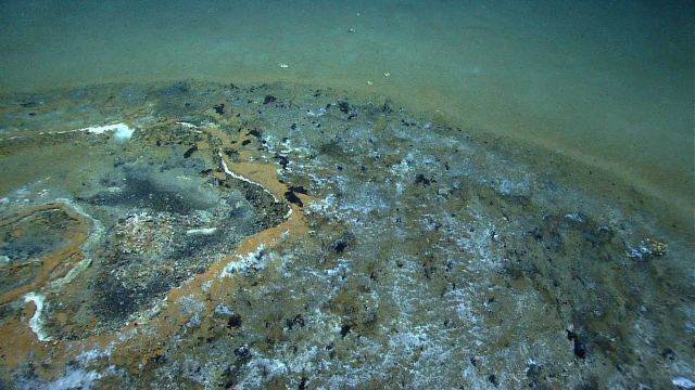 Discolored natural gas and tar seep area. Picture