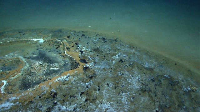 Discolored natural gas and tar seep area. Picture