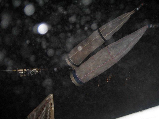 Deploying bongo nets on a rainy night. Picture