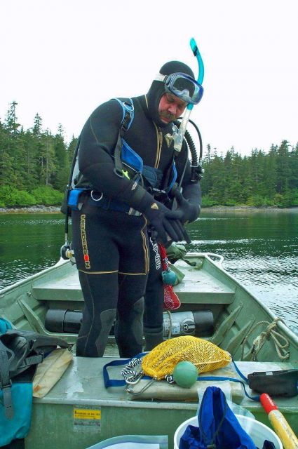 Preparing for a SCUBA dive in cold water to retrieve a temperature probe. Picture