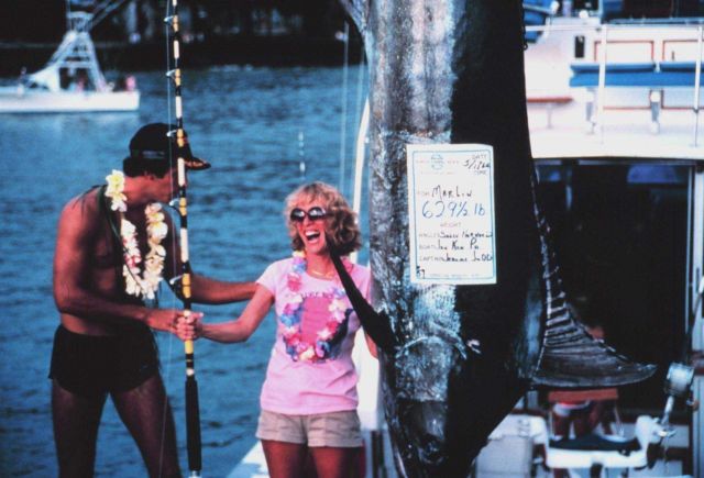 Happy angler standing next to 629 and 1/2 pound marlin at Hawaiian Billfishing Tournament. Picture