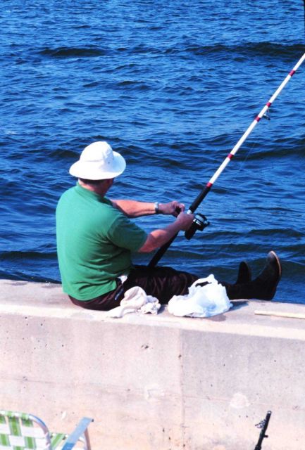 Man fishing from the seawall along Manasquan Inlet. Picture