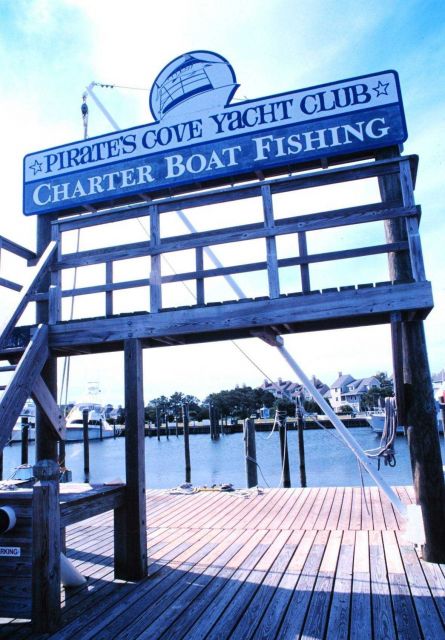 Sign advertising charter boat fishing at Pirate's Cove Yacht Club Picture