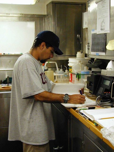 Scientist entering information in journal on the NOAA Ship McARTHUR Picture