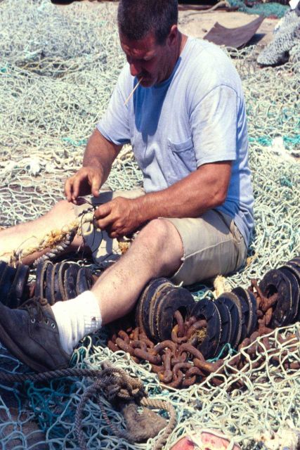 Mending nets usually falls to the same people who set them, like this Pt Picture