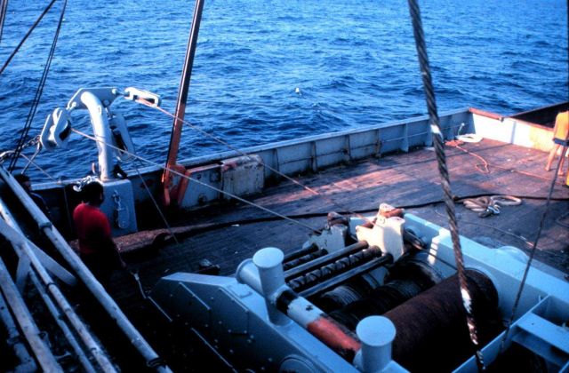Another view of hauling on the cables to close the net. Picture