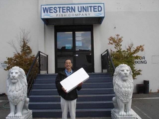Allen Shimada outside the Western United Fish Company facility with a nice box of salmon. Picture