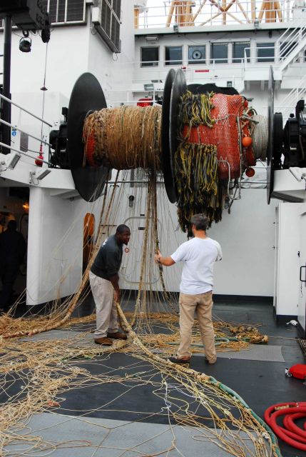 Mending Aleutian wing trawl net. Picture