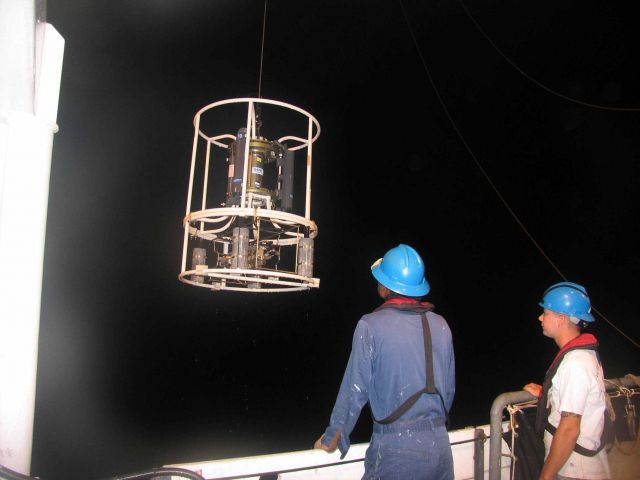 CTD (conductivity-temperature-depth sensor) with water bottles being deployed. Picture