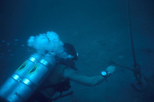 Scuba diver working with underwater equipment deployment Picture