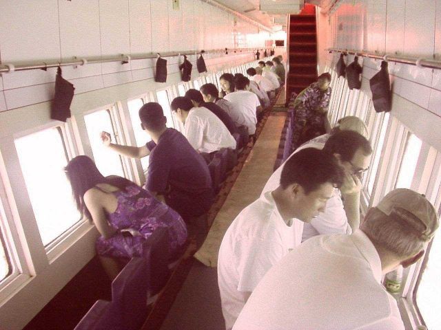 American and Chinese scientists touring Hainan sea in glass bottom boat. Picture