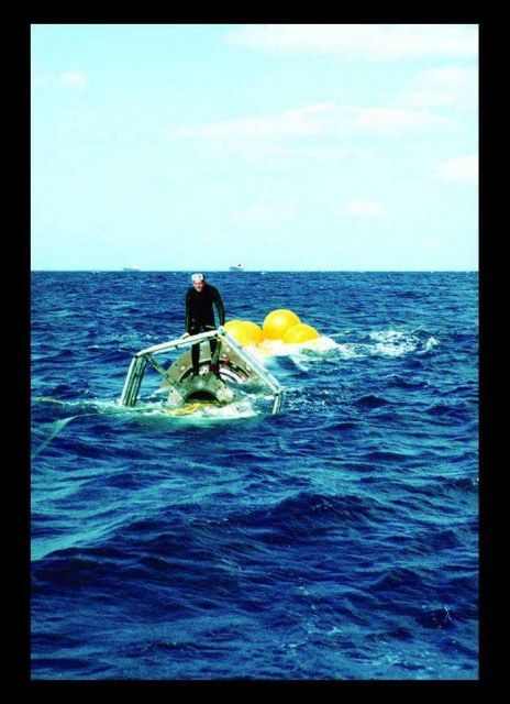 Underwater sea cage being towed offshore in Hawaii for setup. Picture