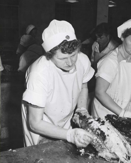 Skinning cooked tuna before canning. Picture