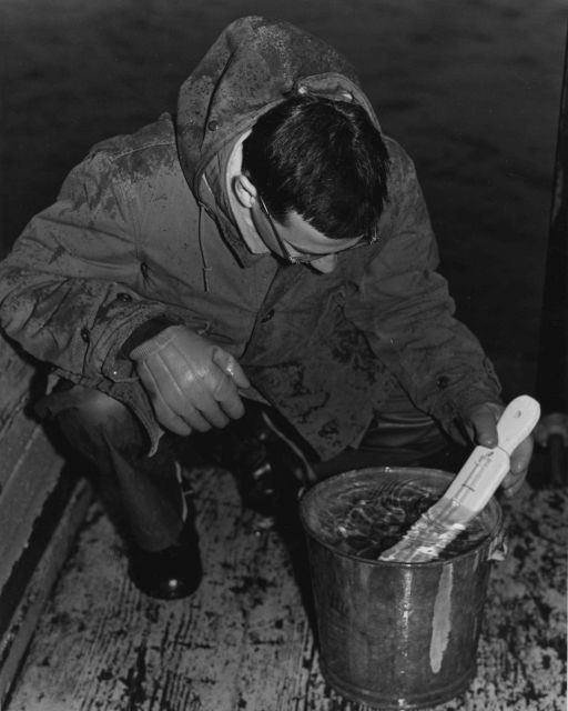 Reading sea water surface temperature from bucket. Picture